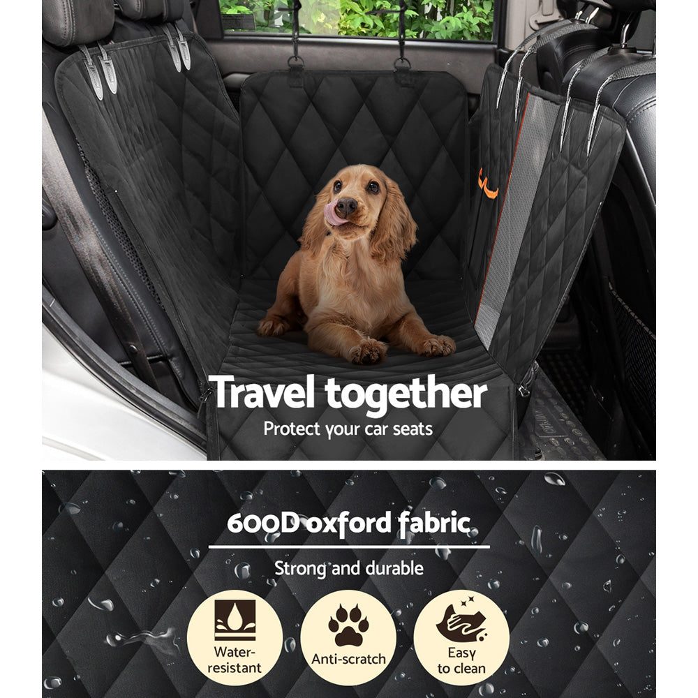 Spaniel sitting on the seat cover in a car